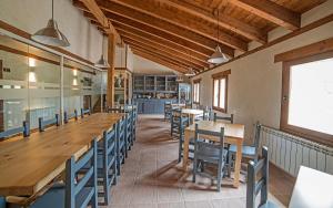 a dining room with wooden tables and chairs at Santa Brigida - Real 1 in Hontanas