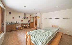 a kitchen with a table with a checkerboardkered table cloth at Santa Brigida - Real 1 in Hontanas