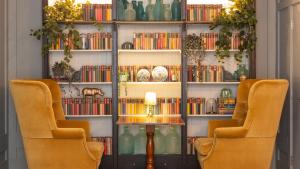 two chairs in front of a book shelf with books at Number 38 Clifton in Bristol
