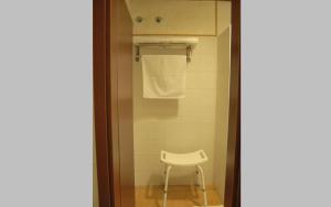 a bathroom with a white chair and a towel at Santa Brigida - Real 1 in Hontanas