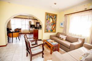 a living room with a couch and a table at Oria Guest House in Cape Town