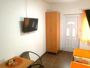 a room with a table and a tv on the wall at Studio Isakovic Centar in Soko Banja