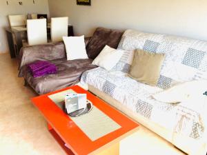 a living room with a couch and a table at Apartamento Costa Brava in Palafrugell