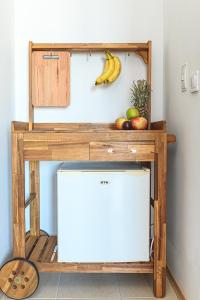 a wooden stand with a banana and fruit on it at The Monkee Studios in Sveti Vlas