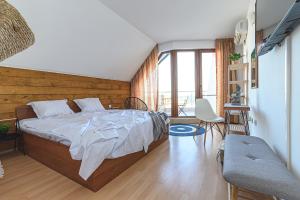 a bedroom with a bed with a wooden wall at The Monkee Studios in Sveti Vlas +23 photos