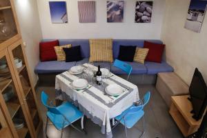 a living room with a table and a blue couch at Domus Titiana Amazing Apartment in Trastevere in Rome