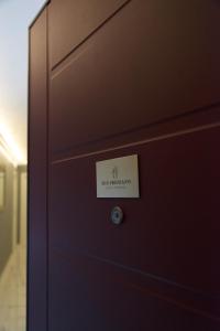 a door with a sign on it in a room at Sun Frediano Suites Florence in Florence