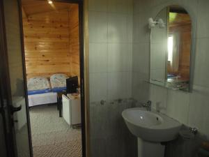 a bathroom with a sink and a bedroom at Lozyata Guest House in Obzor +40 photos