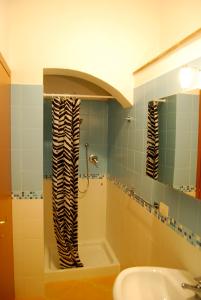 a bathroom with a shower and a sink and a tub at Casa Vacanze Gorgonia in Castellammare del Golfo