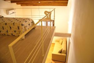 カステッランマーレ・デル・ゴルフォにあるCasa Vacanze Gorgoniaの階段、ベッド、ソファが備わる客室です。