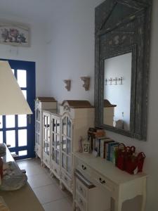 a room with a mirror and a dresser with books at Christos Rooms in Palaiochora