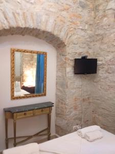 a bedroom with a mirror and a bed at Boutique Hotel Tsopela in Skiathos Town