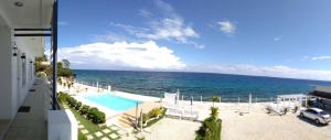 a view of a swimming pool and the ocean at Seascape Beach Resort Oslob in Oslob