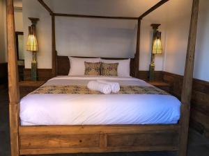 a bedroom with a bed with two towels on it at Melati Bali 2 in Canggu