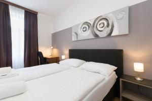 Łóżko lub łóżka w pokoju w obiekcie Vienna Stay Apartments Pezzl 1170