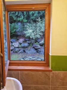 a bathroom window with a view of a stone wall at Suite ad Antagnod in Champoluc