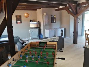 a living room with a pool table in the middle at Gîte Les papillons in Ribeauvillé