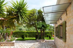 a stone building with a window and a tree at Villa Melody Private Pool Villa with Mountain Views in Fternón