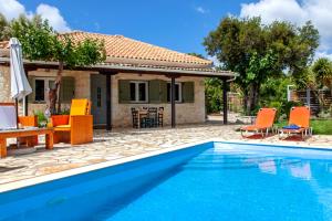 a villa with a swimming pool in front of a house at Villa Melody Private Pool Villa with Mountain Views in Fternón