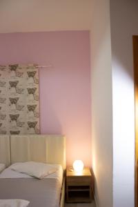 a bedroom with a bed and a lamp on a table at Rizos Studio Sarakiniko in Sarakiniko