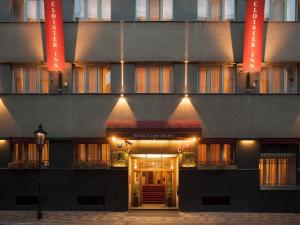 un edificio con la puerta principal iluminada por la noche en Cloister Inn Hotel en Praga