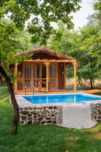 a small house with a pool in the yard at Suna Village Hotel & Bungalow Fethiye in Fethiye