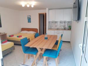 a kitchen and dining room with a wooden table and chairs at Villa Star in Drvenik