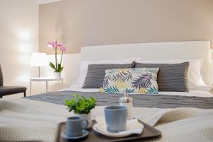 a bedroom with a bed with a table with cups and plates at Home & Pet - Fiori in Basiglio