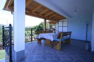 a dining room with a table and chairs on a balcony at Villa Roze in Čižići