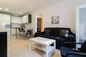 a living room with a couch and a table at De Hofnar Apartments Albufeira in Albufeira