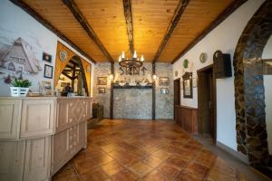 a large hallway with a stone wall and wood ceiling at Arcso Fogado in Corund