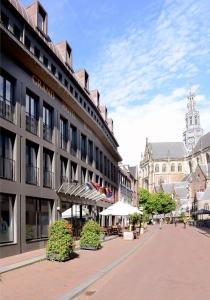 a building on a street in a city at Amrâth Grand Hotel Frans Hals in Haarlem