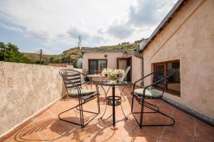 a patio with two chairs and a table on a balcony at Caravan Villa in Tbilisi City