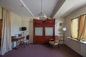 a room with a desk and a door with a chair at Caravan Villa in Tbilisi City