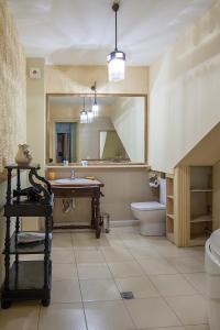 a bathroom with a sink and a toilet and a mirror at Caravan Villa in Tbilisi City +51 photos