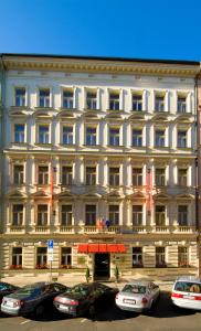 a large building with a sign on the side of it at Hotel Malá Strana in Prague