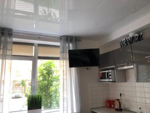 a kitchen with a window and a television in it at Smart Studio New York 2 in Irpin