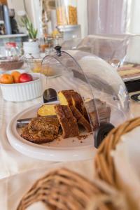 a plate of food on a table with a plate of bread at Fragoulis Village in Parasporos