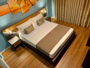 a bedroom with a large bed with a wooden headboard at EKA Luxury Two-Bedroom Premium Apartment 2 in Durrës