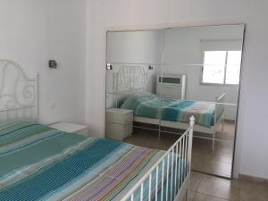 a bedroom with two beds and a large mirror at Paraiso 12 - 1bedroom in Playa Paraiso +21 photos