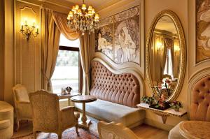 a living room with a couch and a mirror at Excelsior Hotel & Spa Baku in Baku