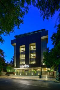 a building with the name of the hotel at night at Centro in Pune