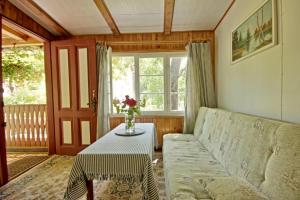 a living room with a couch and a table at Domek Letni Bałtycka in Sopot