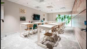 a row of tables and chairs in a room at Original Sokos Hotel Wiklund in Turku +76 photos