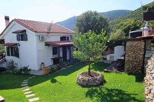 a small tree in the yard of a house at ANGELS'TREASURE VILLA Heavens Knights in Magoúla