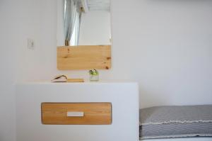 A bed or beds in a room at Yialos Ios Hotel