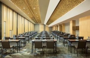 a large dining room with tables and chairs at Swiss-Belresort Dago Heritage in Bandung +122 photos