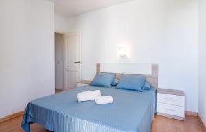 a bedroom with a blue bed with two towels on it at LA PLATERA " Seaview " in L'Estartit +29 photos