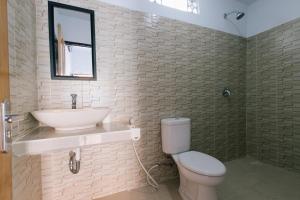 a white bathroom with a sink and a toilet at Pluto House in Canggu +82 photos