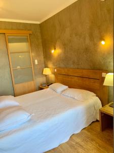 a bedroom with a large white bed with two pillows at A Pasturella in Monticello